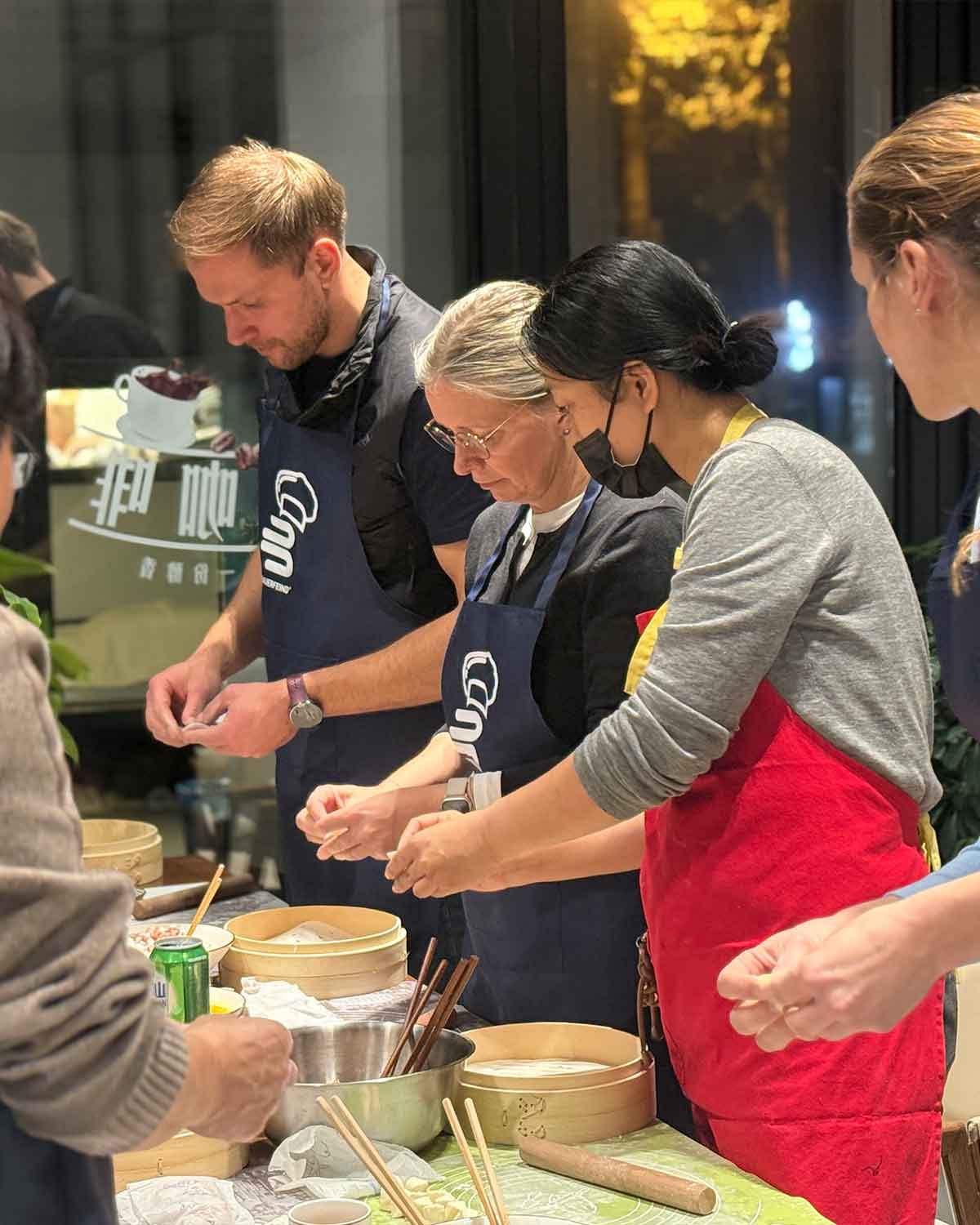 Cici guiding guests as they make dumplings